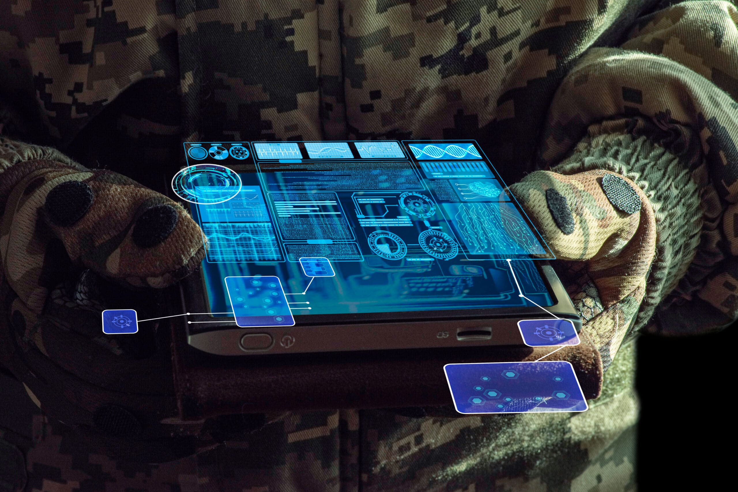 soldier holding a tablet with data dashboard displayed